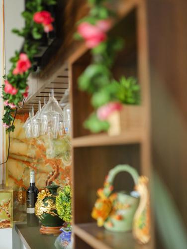 a shelf with flowers and a toy duck on it at Sea View Hotel Phan Thiet in Bình Sum