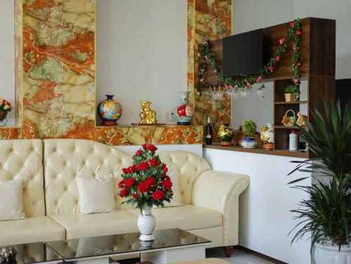 a living room with a couch and a table with a christmas tree at Sea View Hotel Phan Thiet in Bình Sum