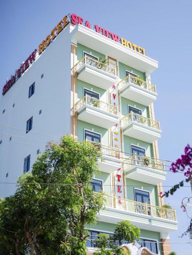 a tall white building with a sign on it at Sea View Hotel Phan Thiet in Bình Sum