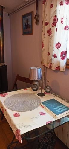 a table with a lamp on top of it at Agroturystyka Stajnia Dorado Pokoje Gościnne i Apartamenty in Leoncin