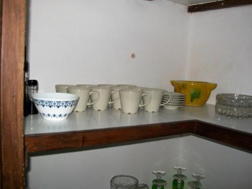 a shelf with a bunch of cups on it at Luna11 in Alcañiz