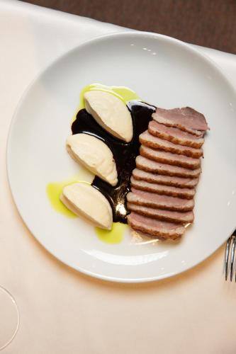 a white plate with a piece of chocolate dessert at Pećina Stroga - Bjelica Winery Rooms in Sremski Karlovci
