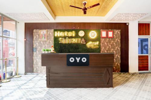 a hotel lobby with a sign on the wall at Hotel O Shivam Grand in Gorakhpur