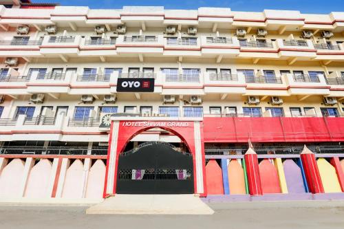 an apartment building with an archway in front of it at Hotel O Shivam Grand in Gorakhpur