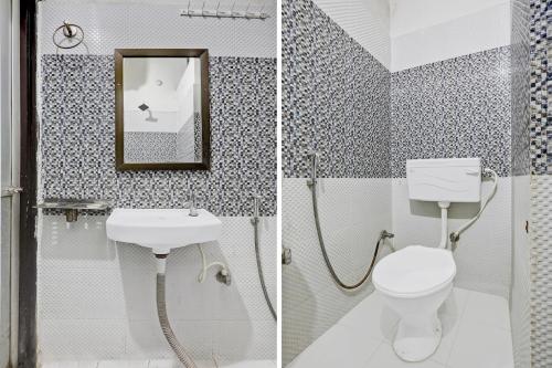 a bathroom with a toilet and a sink and a mirror at Hotel O Shivam Grand in Gorakhpur