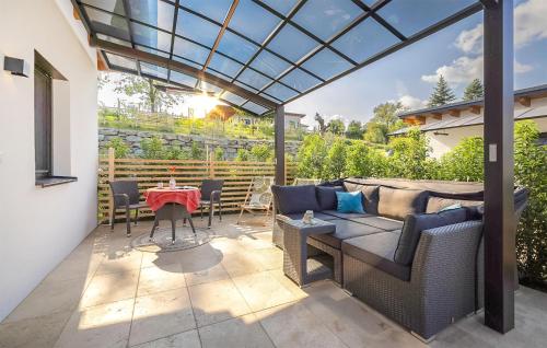 a patio with a couch and a table at Awesome Home In Stegersbach With Sauna in Stegersbach