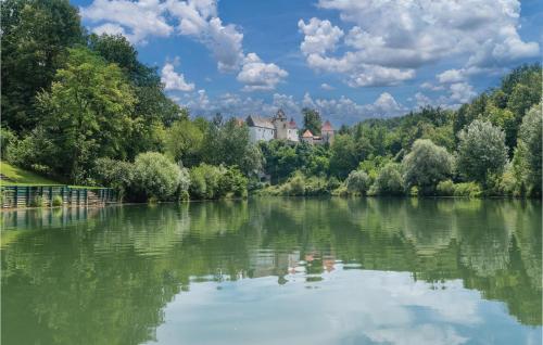 a view of a river with a castle in the background at 1 Bedroom Amazing Home In Ozalj in Ozalj