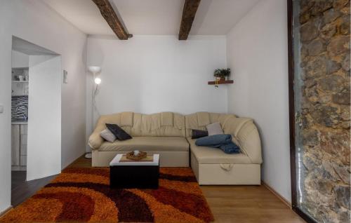 a living room with a couch and a table at 1 Bedroom Amazing Home In Ozalj in Ozalj