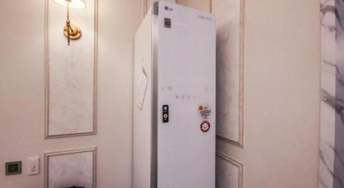 a white refrigerator in a room next to a door at Hotel Seowa in Gimhae