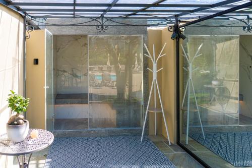a glass door in a room with a table at Villa Vitali - Bellagio in Bellagio