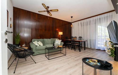 a living room with a green couch and a table at Beautiful Home In Starigrad - Paklenica With Wifi in Starigrad-Paklenica