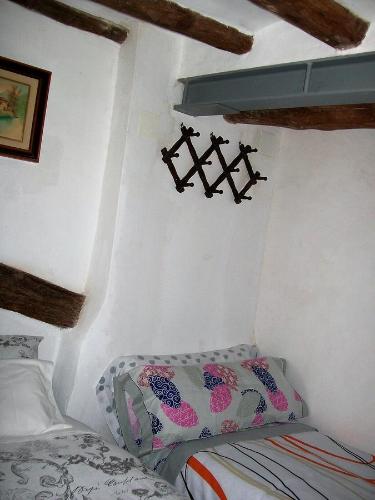 a bedroom with a bed and a shelf on the wall at Luna11 in Alcañiz