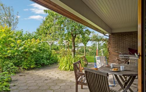 a patio with a table and chairs on a patio at 2 Bedroom Pet Friendly Home In Thisted in Thisted