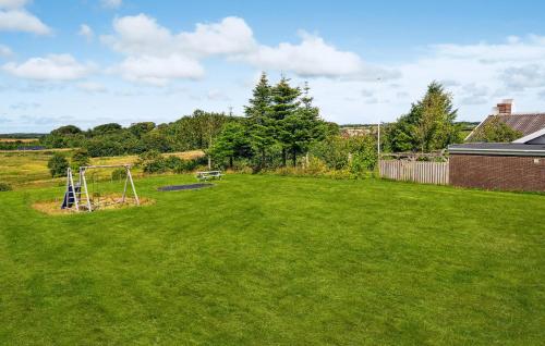a yard with a swing set in the grass at 2 Bedroom Pet Friendly Home In Thisted in Thisted