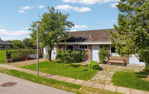 a house with a bench in the yard at 2 Bedroom Pet Friendly Home In Thisted in Thisted