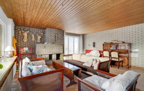 a living room with a couch and a table at 2 Bedroom Pet Friendly Home In Thisted in Thisted