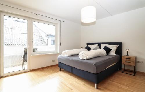a bedroom with a bed and a large window at Ferienwohnung In Bludenz in Bludenz