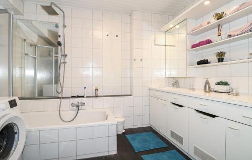 a white bathroom with a sink and a washing machine at Ferienwohnung In Bludenz in Bludenz
