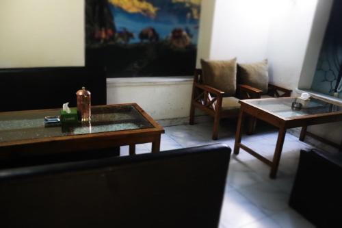 a living room with a coffee table and chairs at Hotel Kailash Mansarobar Banquet and Restaurant in Kathmandu