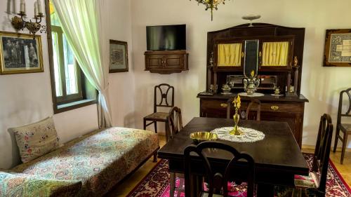 a dining room with a table and a chair at Locul cu Amintiri in Albac