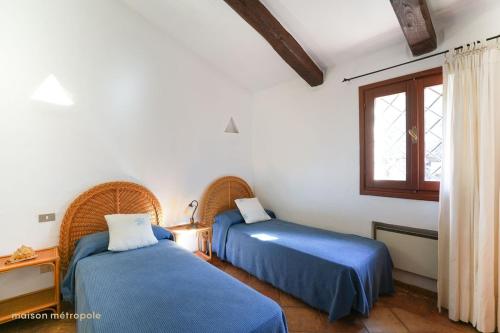 Кровать или кровати в номере Porto Cervo House, giardino e piscina condominiale