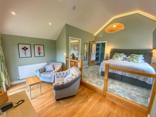 a bedroom with a bed and a living room at Pen-Y-Dyffryn Country Hotel in Oswestry