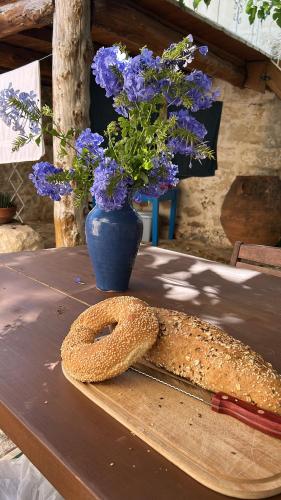 a table with a vase with purple flowers and a knife at Old stone villa in Apokoronas Villa Nostalgia Kreta in Fílippos