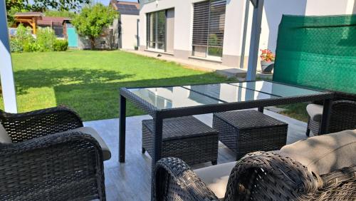 a glass table and chairs on a patio at Morning Coffee in Ljubljana