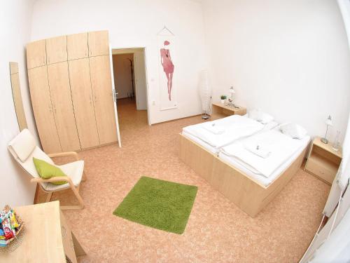 a room with a bed and a chair and a mirror at 7nights Apartments Dominikánské naměstí in Brno