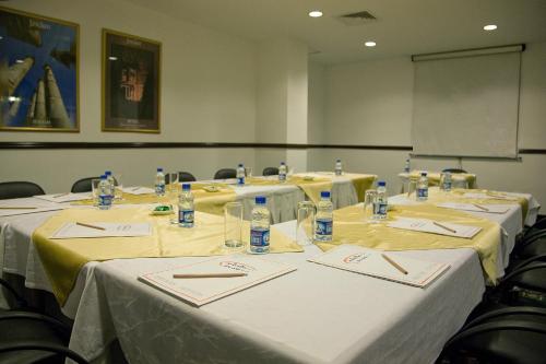 a group of tables with bottles of water on them at Toledo Amman Hotel in Amman