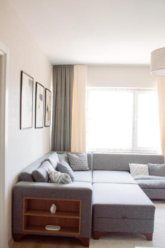 a living room with a couch and a window at Luxe Suite AI28 in Esenyurt