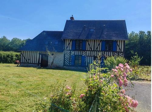 a house with blue and white stripes on it at La maison bleue in Reux