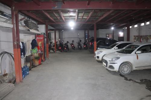 a garage with cars and motorcycles parked in it at Hotel Kailash Mansarobar Banquet and Restaurant in Kathmandu