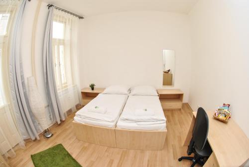 a bedroom with a bed and a desk and a desk at 7nights Apartments Dominikánské naměstí in Brno