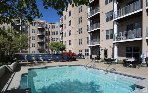 a swimming pool in the courtyard of a apartment building at CozySuites - Current at the Banks in Cincinnati
