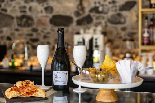 a bottle of wine and two glasses on a counter at Villa Vitali - Bellagio in Bellagio