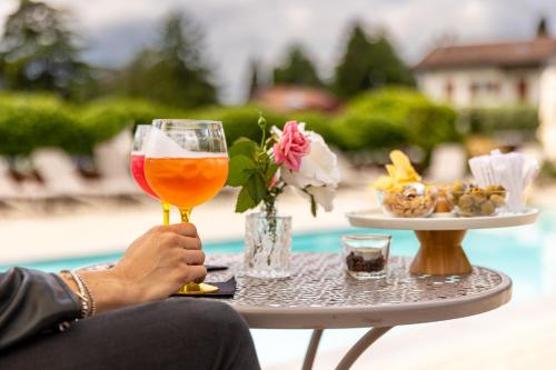 a person holding a glass of beer and a tray of food at Villa Vitali - Bellagio in Bellagio