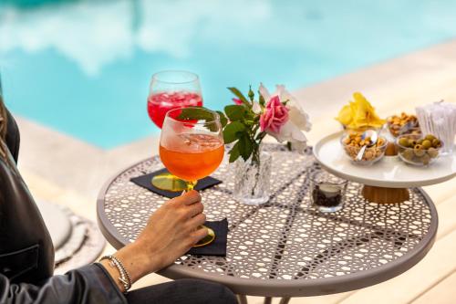 a person sitting at a table with a glass of beer at Villa Vitali - Bellagio in Bellagio