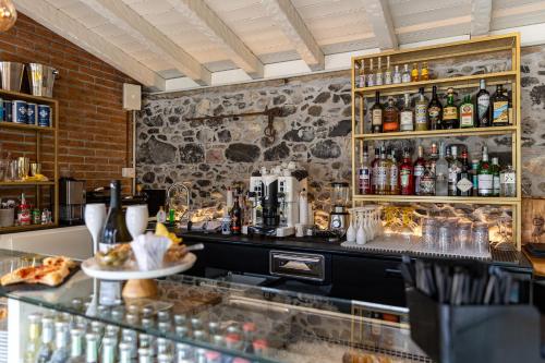 a bar with a counter with a lot of alcohol at Villa Vitali - Bellagio in Bellagio