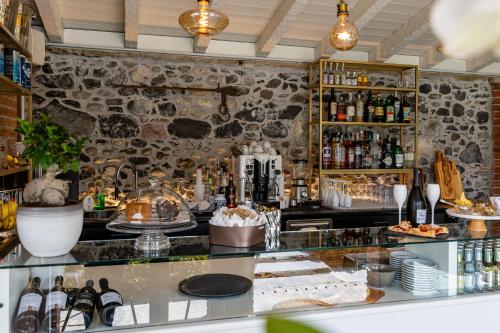 a bar in a restaurant with a stone wall at Villa Vitali - Bellagio in Bellagio