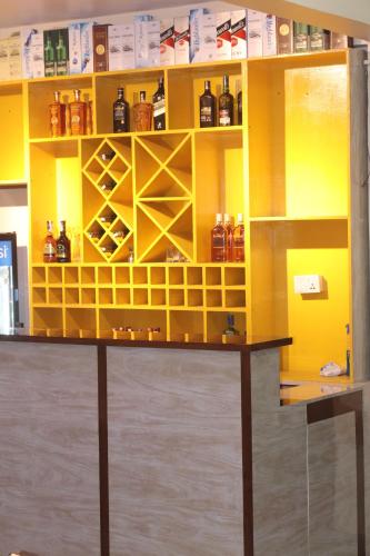 a yellow shelf with bottles on it at Hotel Kailash Mansarobar Banquet and Restaurant in Kathmandu