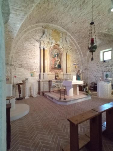 a large room with a church with a painting on the wall at Casa Pie' di Monte Refuge in Bisegna