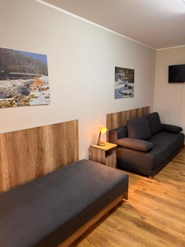 a living room with a bed and a couch at 4 Pory Roku - Węgierska Górka in Węgierska Górka