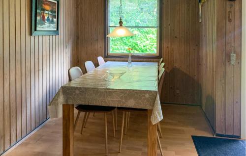 a dining room with a table and chairs and a window at 2 Bedroom Lovely Home In Silkeborg in Silkeborg