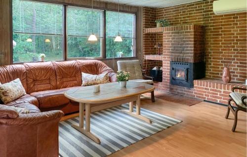 a living room with a couch and a fireplace at 2 Bedroom Lovely Home In Silkeborg in Silkeborg