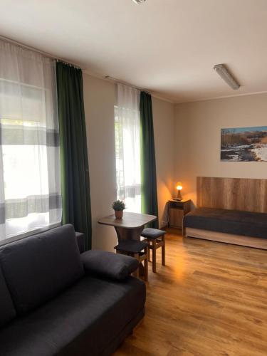 a living room with a couch and a table at 4 Pory Roku - Węgierska Górka in Węgierska Górka