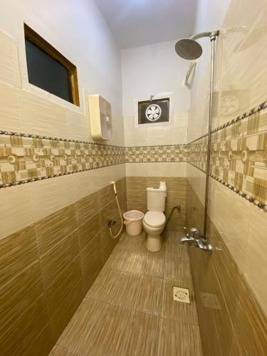 a bathroom with a toilet and a shower at Johar Guesthouse-Suite 3Bed and Lounge in Karachi in Karachi