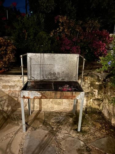 a bench with a bird cage on top of it at Old stone villa in Apokoronas Villa Nostalgia Kreta in Fílippos