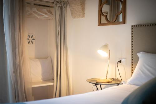 Masseriola Antiche Fogge by Apulia Hospitalityにあるベッド