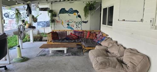 a living room with a couch and a table at Ninja Camp - Dojo - Muay Thai Retreat in Baan Tai
